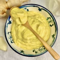 Ginger and garlic paste blended to a smooth paste in a blue and white bowl.