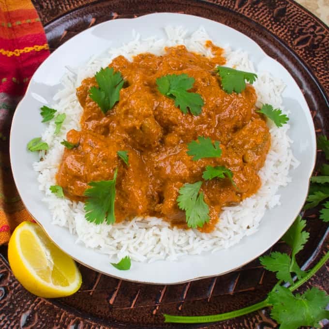 Easy Butter Chicken (Murgh Makhani)Served on a bed of rice and garnished with cilantro.