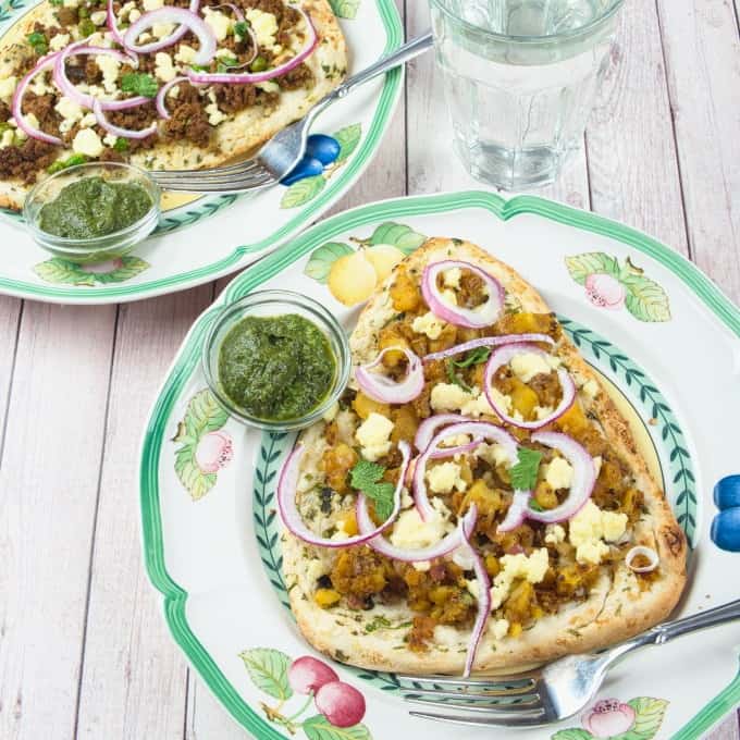 Naan pizza toped with keema (Indian ground beef), pickled onions, and chutney