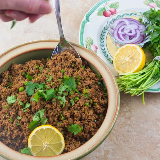 Weeknight Beef Keema Curry An easy ground meat dinner served with a flutter of roughly chopped cilantro and a wedge of lemon.