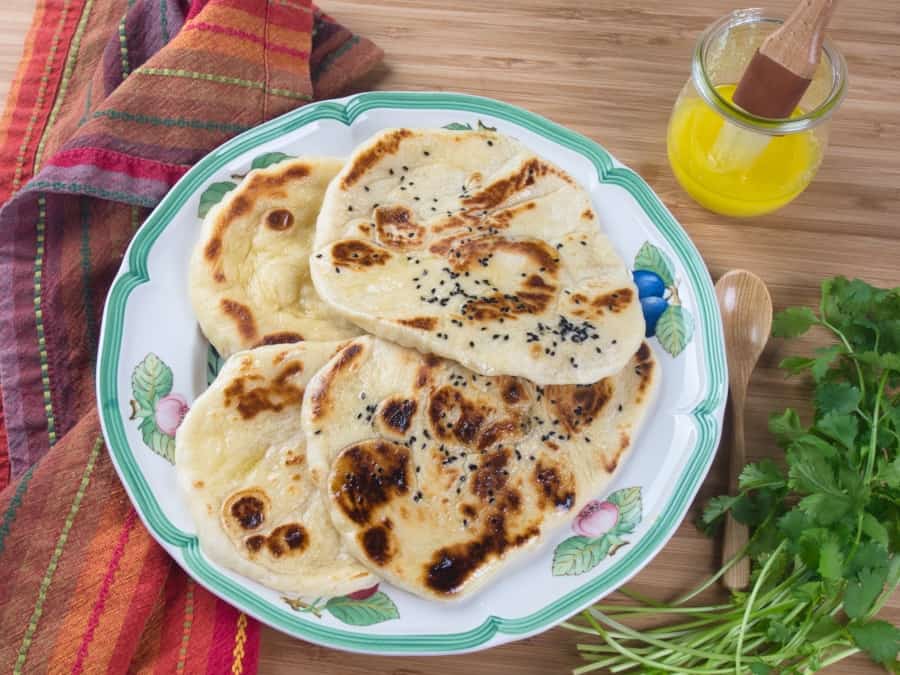 Homemade Naan (No-Yeast) Four naan served with a side of ghee.