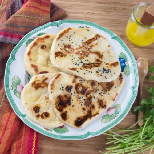 Homemade Naan (No-Yeast) Four naan served with a side of ghee.