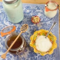 How to Make Homemade Yogurt (Stove) Homemade yogurt served with honey and nuts.