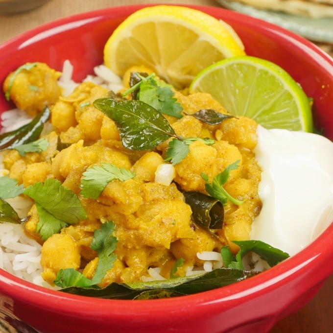 Served over rice with a dollop of raita and wedges of lime.