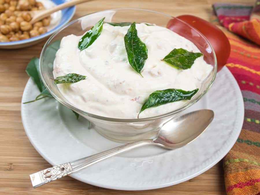 Cooling Tomato Raita - An Indian yogurt salad flavored with tomato and spices and garnished with fried curry leavesA perfect side for anything you are eating.