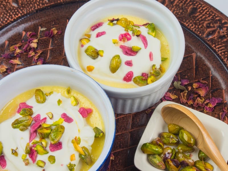 Sweet & Creamy Chai Pudding - Served with a cloud of whipped cream and a shower of pistachios and candied rose petals.Sweet & Creamy Chai Pudding