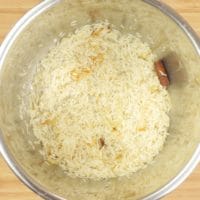 Simple Ghee Rice (Nei Choru) - The rice and flavorings ready to be cooked.