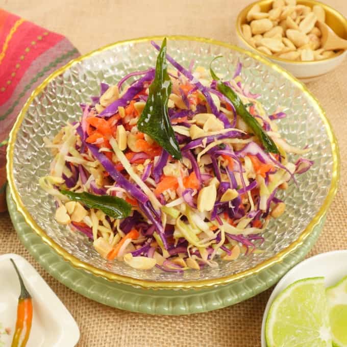 Indian-ish Coconut Cabbage Salad Served with a slice of lime, a small fresh chili, and extra peanuts on the side.
