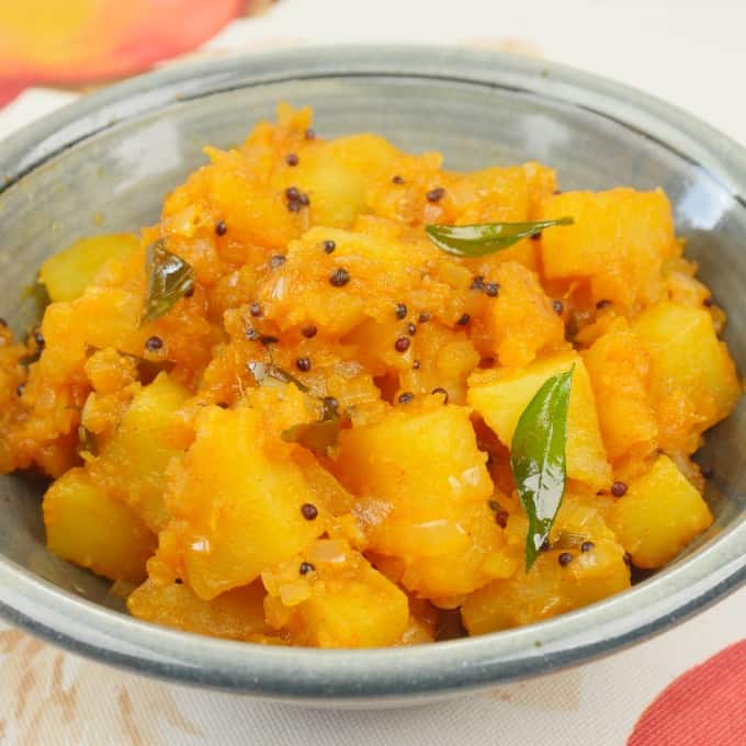 A beautiful bowl of aloo masala with popped mustard seeds and spluttered curry leaves.