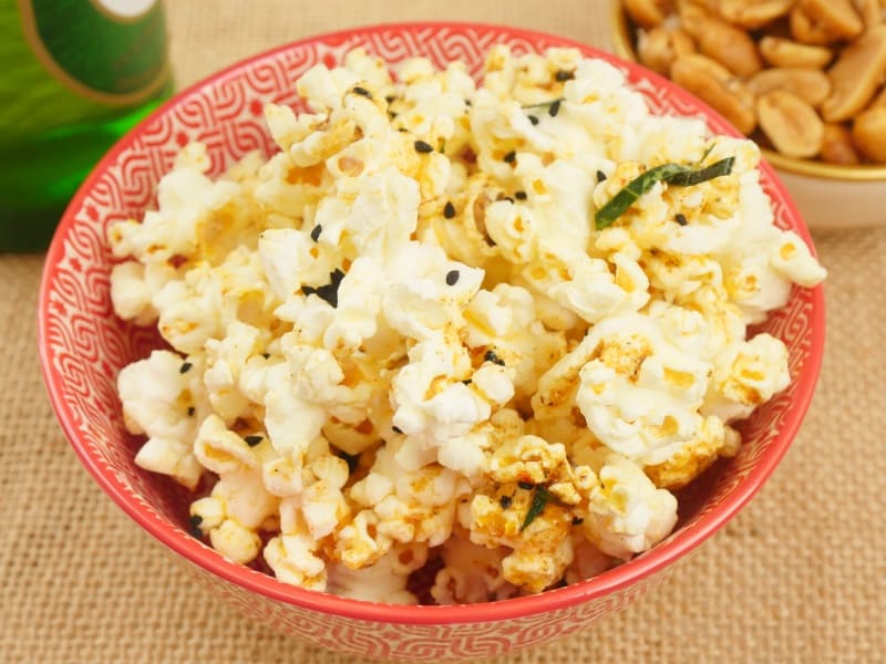 Easy Microwave Curry Popcorn Served with sweet and salty nuts and flavored with Indian spices.