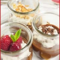 Dished out into jars for individual servings garnished with berries, peanuts, and chocolate shavings.