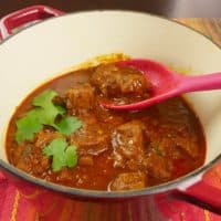 A pork masala served in a beautiful red dutch oven. Rich with spices and chilies, this is the curry of your dreams.