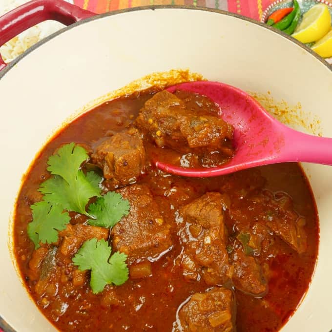 A pork masala served in a beautiful red dutch oven. Rich with spices and chilies, this is the curry of your dreams.