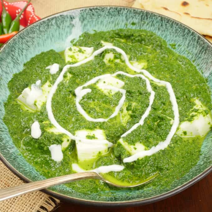 Served with a dusting of fresh cilantro with white cubes of paneer peaking out of the bright green sauce.