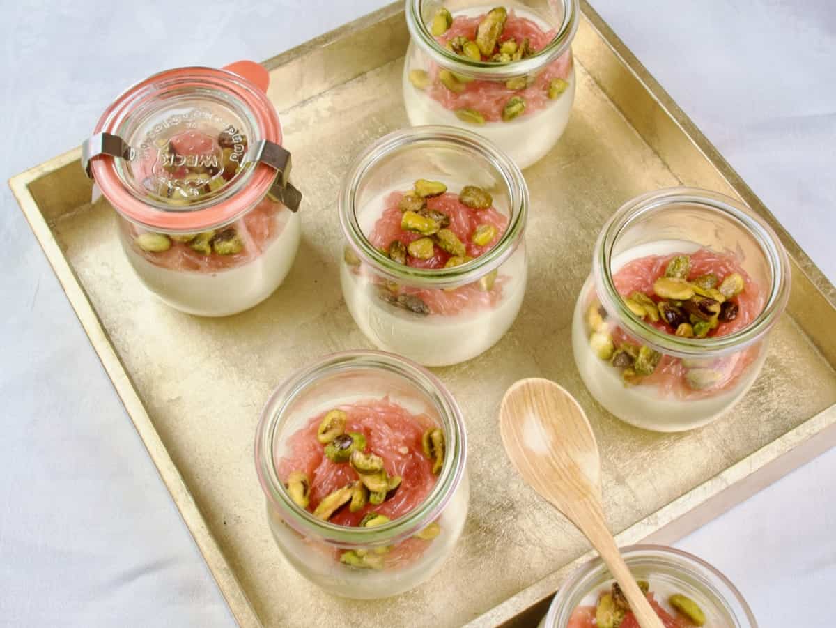 Served in small glass jars and topped with grapefruit and candied pistachios.