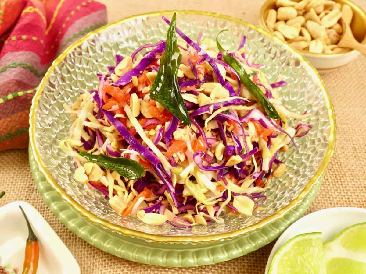 Indian-ish Coconut Cabbage Salad Served with a slice of lime, a small fresh chili, and extra peanuts on the side.