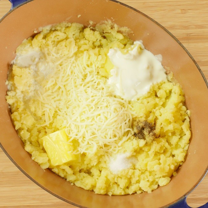 Mashed potatoes getting enriched with half and half and butter for Curried Ground Turkey Shepherd’s Pie