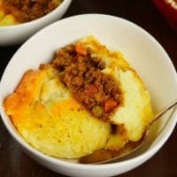 Served up in a bowl with a cheesy mashed potato layer and a rich meat filling.