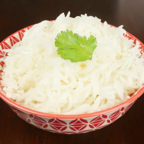 Served in a pretty red and white rice bowl garnished with bright green cilantro.