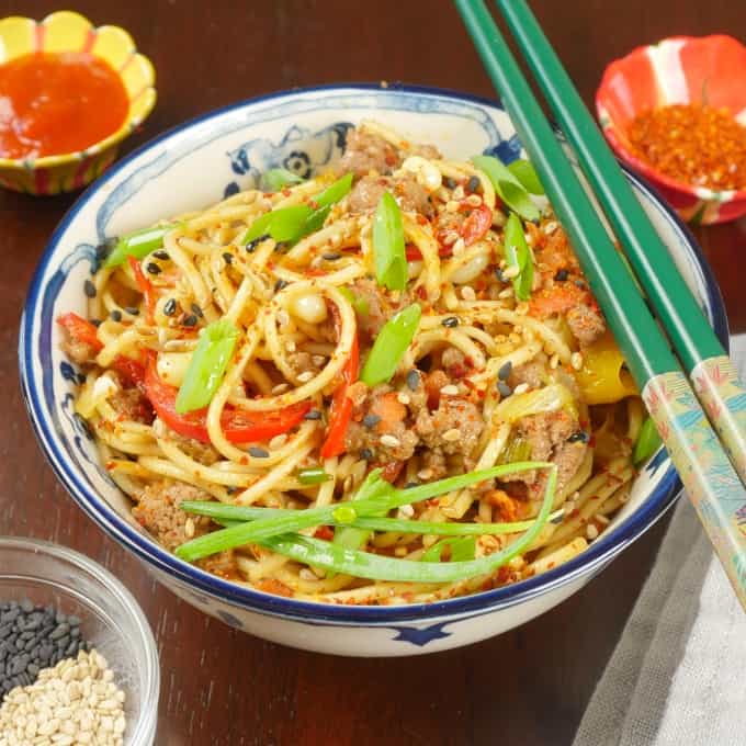 Served in a blue and white Chinese rice bowl garnished with scallion greens and accompanied with a small dish of chili flakes. Served with chopstix.