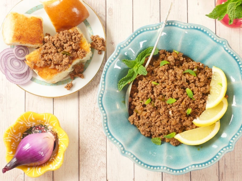 Weeknight Beef Keema Curry Served with buttered, toasted buns, a wedge of lemon, and a flurry of cilantro.