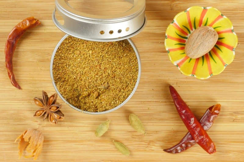 Goan Garam Masala - A spice tine filled with spice powder with whole spices keeping it company.