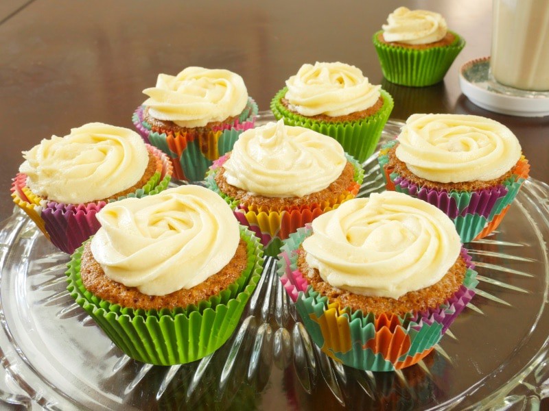 Indianish Carrot Cupcakes Recipe Baked in pretty cupcake papers and frosting with swirls of cream cheese frosting.