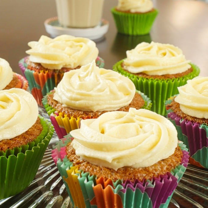 Baked in pretty cupcake papers and frosting with swirls of cream cheese frosting.