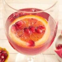 Served in a long-stemmed wine glass with pomegraniate arils and a blood orange slice.
