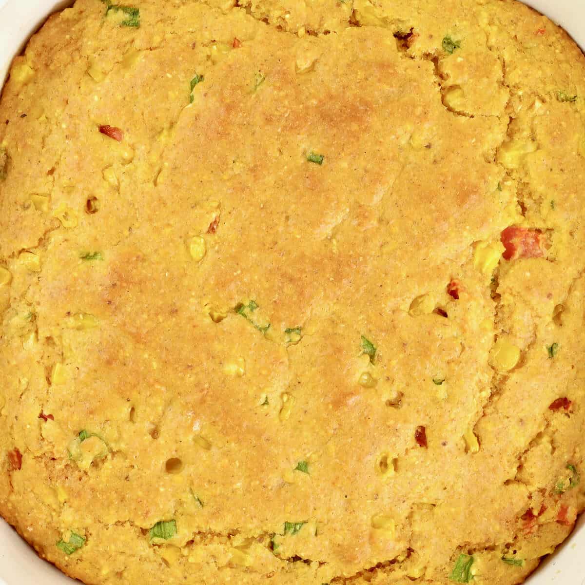 Spicy Cornbread with Corn just baked in a square white glass pan.